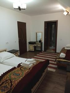 a hotel room with two beds and a mirror at Pensiunea IULIA in Rod +29 photos