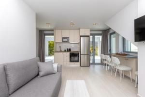 a living room with a couch and a kitchen at Verde Villas in Skala Potamias