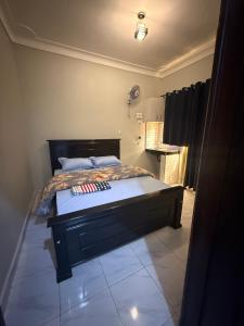 a bedroom with a bed in a room at Crown Motel Lugala in Kampala +9 photos
