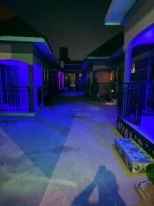 a house with blue and purple lights on it at Crown Motel Lugala in Kampala