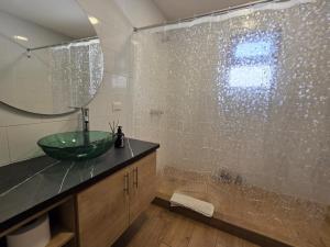 a bathroom with a sink and a glass shower at Dk8 - Nice studio in Zona Viva in Guatemala
