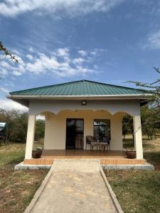 a small house with a green roof at Narasha homestay in Talek
