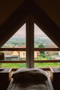 a window in a room with a bed and a view at Domek Panorama in Lipowa