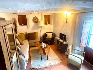 a living room with a couch and a table at 2-Bed Country House - Mountain Views - Sleeps 6 in Rute