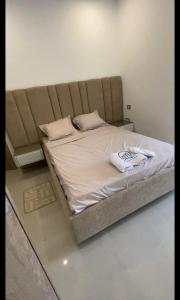 a large bed in a room with a white blanket at Appartement S2 résidence costa '0751' 8402'79 fr in El Ahmar