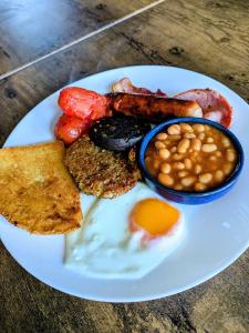 a plate of breakfast food with eggs beans and toast at The Dame Lane in Blackpool