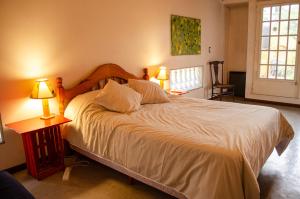 a bedroom with a large bed with two lamps at Casa Pugliese in Buenos Aires +25 photos