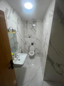 a white bathroom with a sink and a toilet at relaxtime avec ascenceur in El Jadida