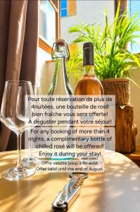a bottle of wine on a table with a glass at Maison atypique médiévale in Saint-Léonard-de-Noblat