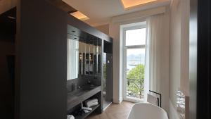 a bathroom with a sink and a large window at Palazzo Montella in Naples