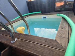 a small pool with a wooden deck and a hot tub at Sunshine in Groß-Zimmern