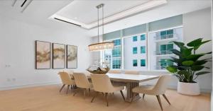 a dining room with a table and chairs and a potted plant at Naples Luxury Retreat in Naples