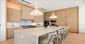 a kitchen with a large island with bar chairs at Naples Luxury Retreat in Naples