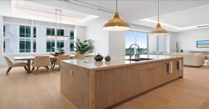 an open kitchen and living room with a table and chairs at Naples Luxury Retreat in Naples