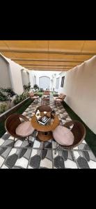 a patio with a table and chairs on a tiled floor at Garden C Hotel Nile Plaza in Cairo