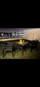a bench and a table in front of a train at Garden C Hotel Nile Plaza in Cairo
