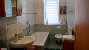 a bathroom with a sink and a toilet at Apartment 24 modern & gemütlich in Dessau +26 photos