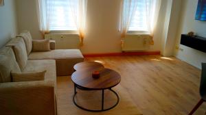 a living room with a couch and a table at Apartment 24 modern & gemütlich in Dessau