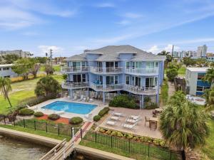 an aerial view of a large blue house with a swimming pool at Amadeus 3 in St. Pete Beach