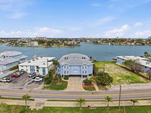 an aerial view of a large blue house next to a body of water at Amadeus 3 in St. Pete Beach