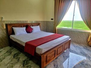 a bedroom with a bed with a large window at Town Tulip in Karativu