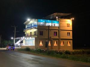 a building at night with a car in front of it at Town Tulip in Karativu +8 photos