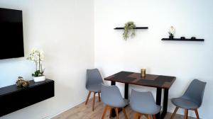 a dining room with a table and blue chairs at Apartment 24 modern & gemütlich in Dessau