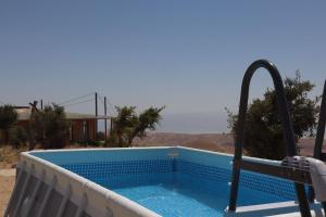 a plunge pool in a house with a view of the desert at Zman Midbar Eco Spirit Lodge for Peace in Arad