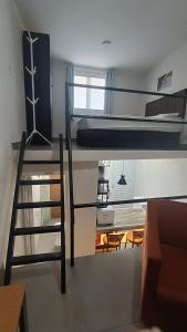 a room with two bunk beds and a living room at Studio Home 4 in Jacareí +18 photos