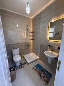 a bathroom with a toilet and a sink and a tub at Chalet in Blumar Ain soknha in Ain Sokhna