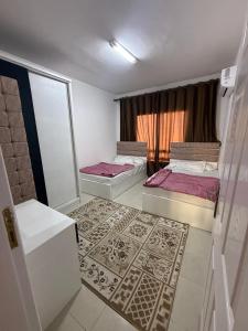 a room with two beds and a window at Chalet in Blumar Ain soknha in Ain Sokhna