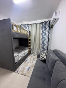 a living room with a couch and bunk beds at Chalet in Blumar Ain soknha in Ain Sokhna