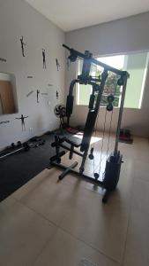 a room with a gym with a treadmill at Studio Home 4 in Jacareí