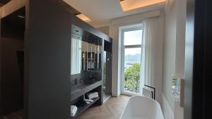 a bathroom with a sink and a large window at Palazzo Montella in Naples +24 photos