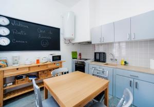 a kitchen with a table and a chalkboard on the wall at Casa da Avenida in Cascais