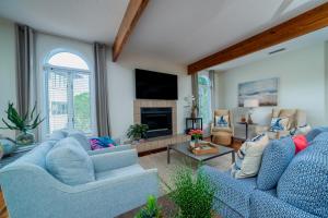 a living room with two blue couches and a fireplace at 3017 Ocean Winds in Seabrook Island