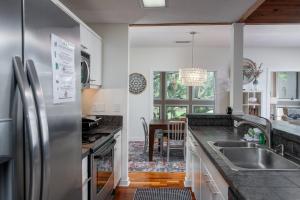 a kitchen with a stainless steel refrigerator and a table at 3017 Ocean Winds in Seabrook Island +33 photos