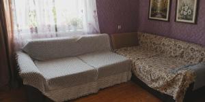 a living room with a couch and a chair at Дом мичти in Tsalka