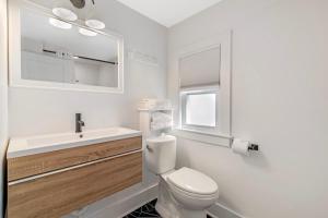 a white bathroom with a toilet and a sink at Ocean Surf at York Beach in York +39 photos