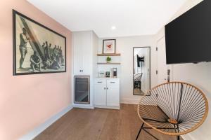 a living room with a chair and a painting on the wall at Ocean Surf at York Beach in York