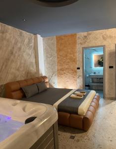 a bedroom with a large bed and a couch at Hotel and Coffee Bar Old Bazaar in Skopje