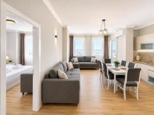 a living room with a couch and a table at Flors Apartments in Durrës