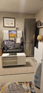 a living room with a couch and a refrigerator at Victoria complex in Willemstad