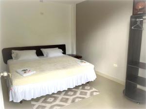 a bedroom with a bed with white sheets and white pillows at FerG in Lligua