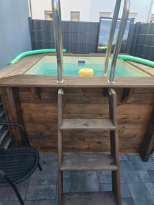 a wooden table with a chair and a pool at Sunshine in Groß-Zimmern