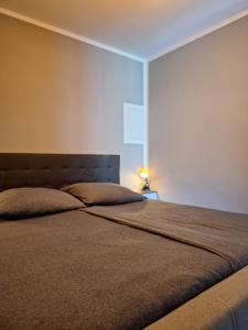 a bedroom with a large bed with a headboard at Fewo RELAX in Borken