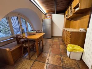 a kitchen with a table and a refrigerator at Il Nido del Gabbiano in Vietri sul Mare