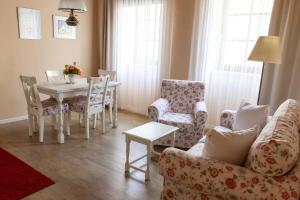 a living room with a couch and a table and chairs at Atriumhof in Rust +19 photos