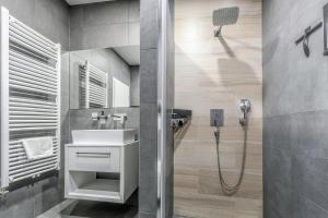 a bathroom with a sink and a shower at Apartmány Prusinovského in Kroměříž +95 photos
