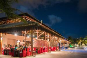 a group of people sitting at tables in front of a building at Vila Galé Resort Cumbuco - All inclusive in Cumbuco